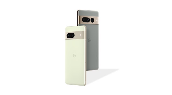 A light green Pixel 7 phone stands next to a grey Pixel 7 Pro phone.