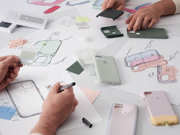 Two people working on drawings of a Pixel phone