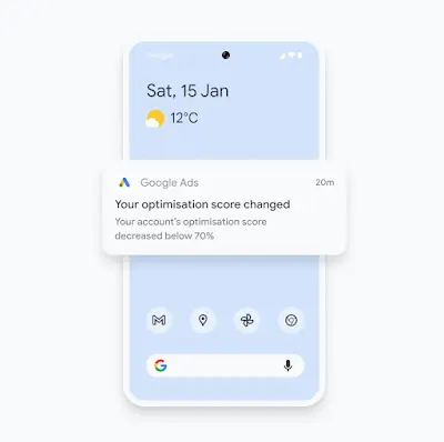 Illustration of a phone showing a Google Ads mobile app notification about an optimisation score change.