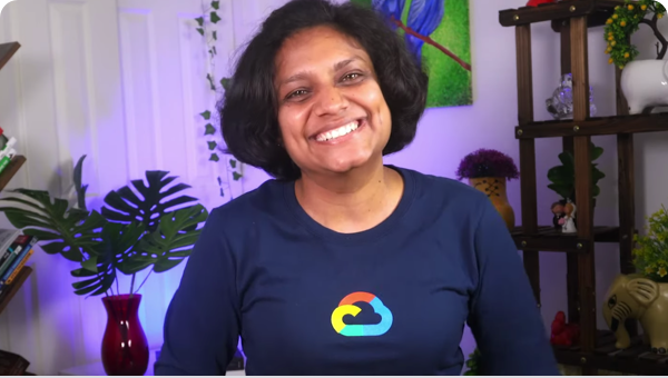 Woman smiling at camera wearing a Google Cloud long-sleeve t-shirt.