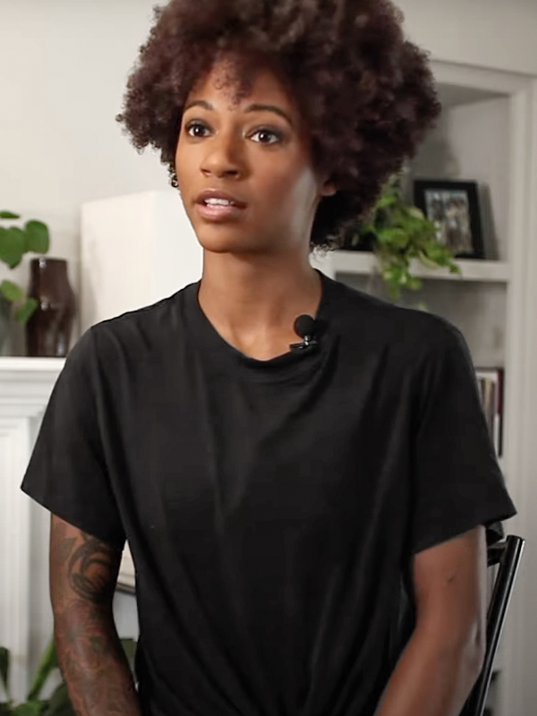 Close up of a woman with an afro wearing a black shirt
