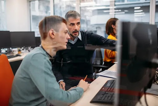 Dos hombres que miran la pantalla de una computadora