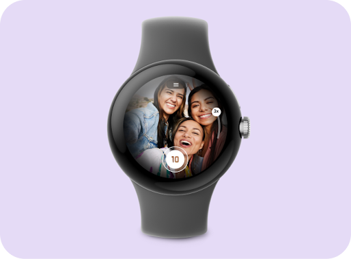 A smartwatch displaying an image of three smiling friends on the screen with a camera button and zoom control.