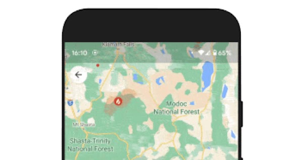 A mobile phone displays a map with green landscape with a number of red, transparent areas representing multiple fire boundaries placed over the map.