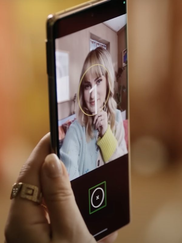 A phone screen shows a blonde woman’s selfie, with the Guided Frame app countdown layered on top
