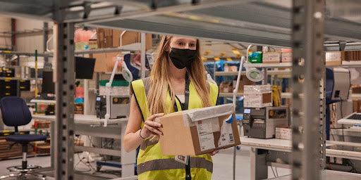 A female worker holding a package 