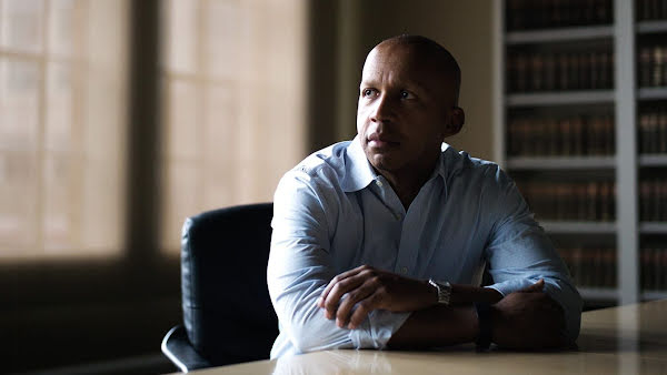 Bryan Stevenson, founder and Executive Director of the Equal Justice Initiative, sitting at a desk