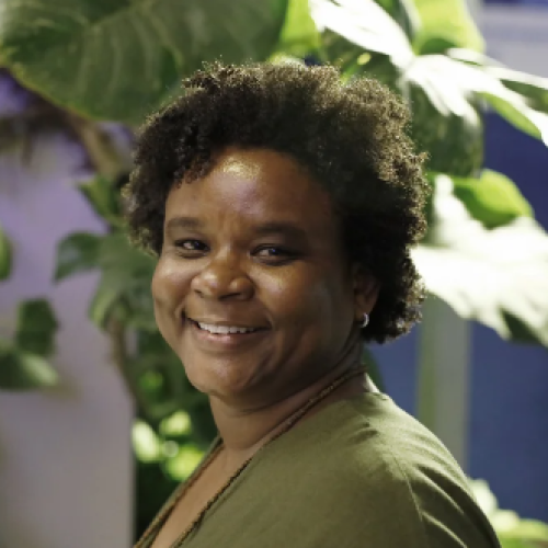 Ana Cabral, a Google for Startups Black Founders Fund recipient, stands smiling in her short curly hair