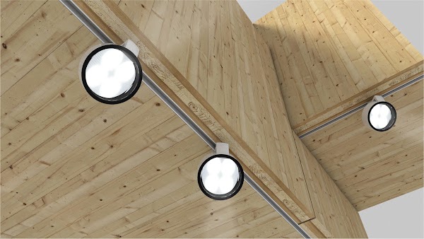 Three whitelighting fixtures hanging from a track along a wood-lined ceiling.