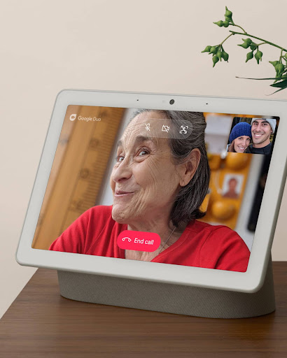 A photo of a Nest Hub device with Google Duo on screen, video chatting with grandparents
