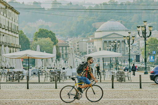 Mattia pedals his bike across Turin’s cobblestone streets