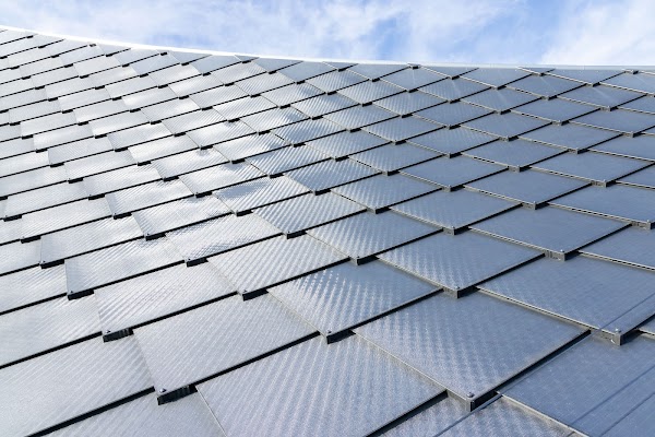 A close-up photo of the building integrated photovoltaics with the sky above.