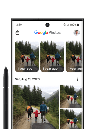 An Android phone screen with Google Photos open shows a grid of photos recently transferred.