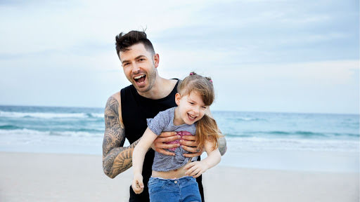 Dwayne and his daughter, Liberty, at the beach in Australia.
