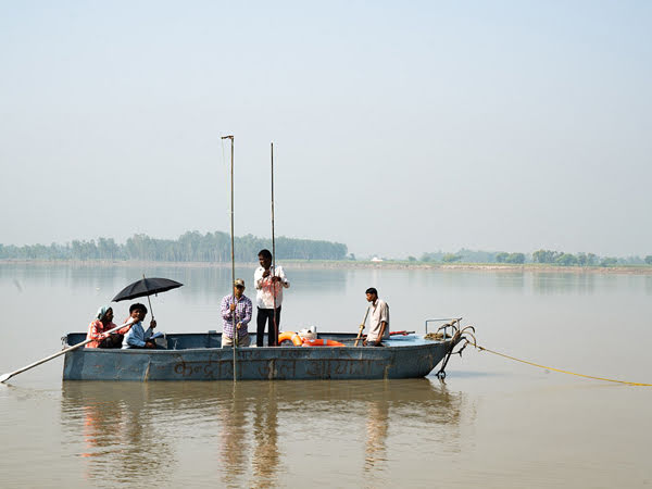 Boat crew measuring river depth in India