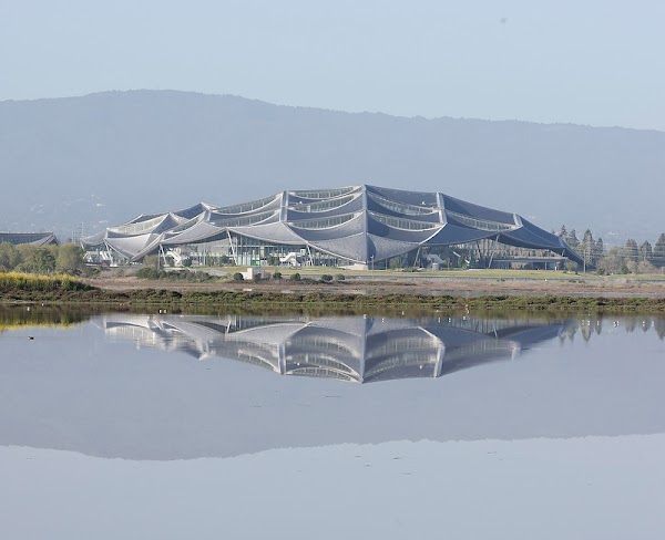 View of Bay View from afar with its reflection in an adjacent water reservoir.