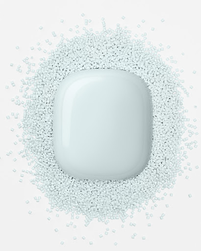 A split-screen of recycled plastic granules on the left and Nest Wifi on the right