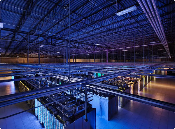 Interior of a Google Cloud data center showing multiple rows of servers from above.
