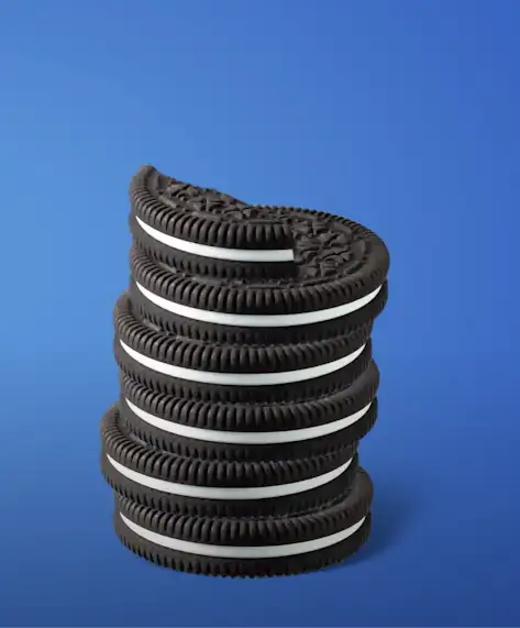 A closeup of an Oreo cookie on a blue background.