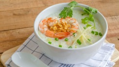 Khao tom goong soup on a table.