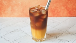 orange juice iced coffee in a glass