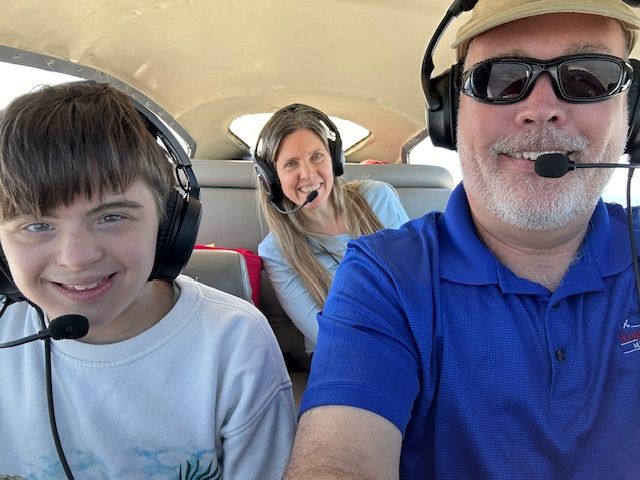 Victory Junction camper and his mom with volunteer pilot from Mercy Medical Angels