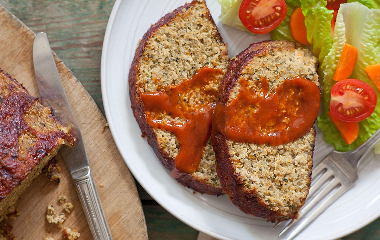 Overhead shot of sliced quinoa-turkey meatloaf recipe with ketchup on plate
