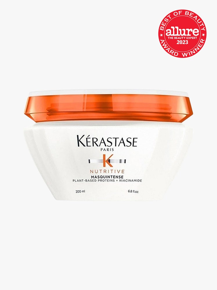 Krastase Nutritive Masquintense white jar with orange cap on light grey background