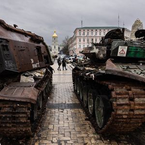 Des passants contemplent des chars russes détruits exposés à Kiev