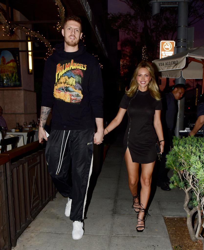 Even in heels, Kellar hardly reaches her 7-foot-tall fiancé.