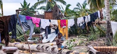 A boy sits amid scenes of destruction in Macomia town after it was hit by tropical cyclone Kenneth.