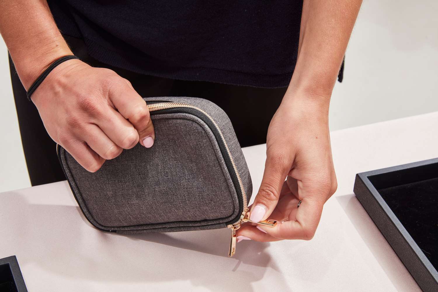 A person zips up the Teamoy Small Jewelry Travel Case