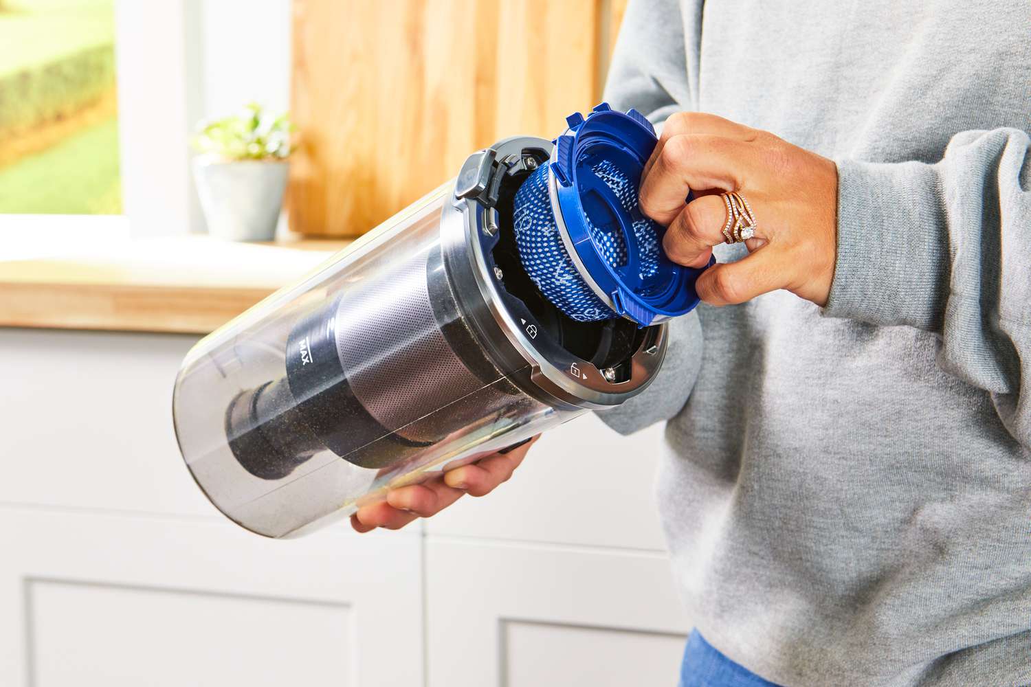 Person holding the canister of the Samsung Jet 75 Cordless Stick Vacuum