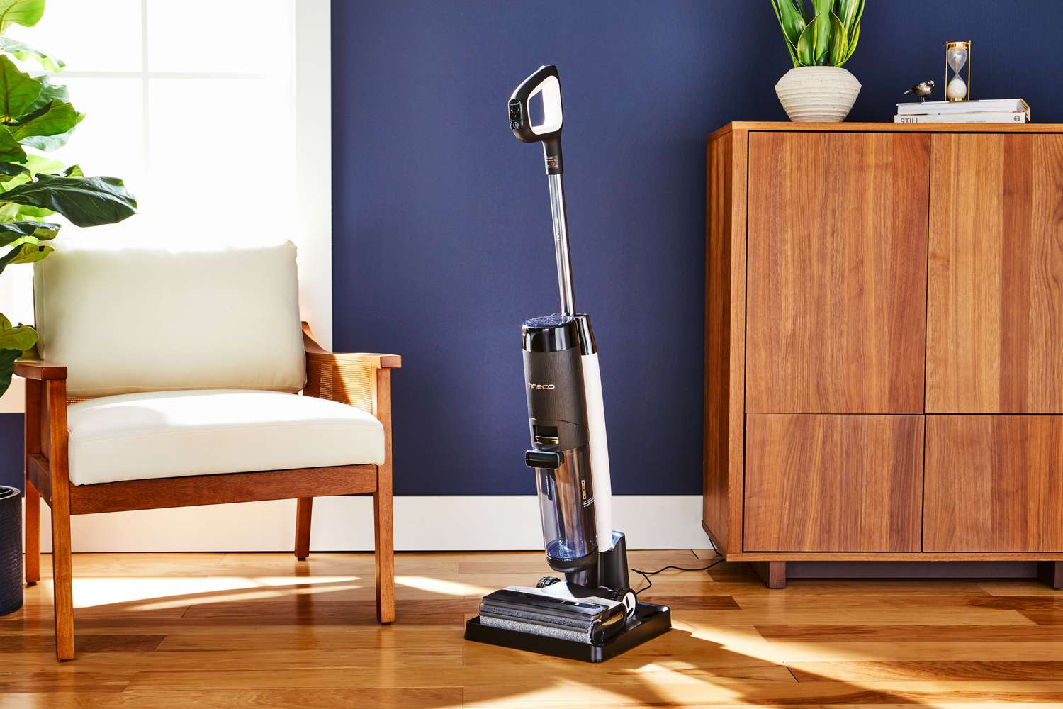 Tineco Floor One S7 Pro Smart Wet Dry Vacuum Cleaner on wooden floor next to furniture