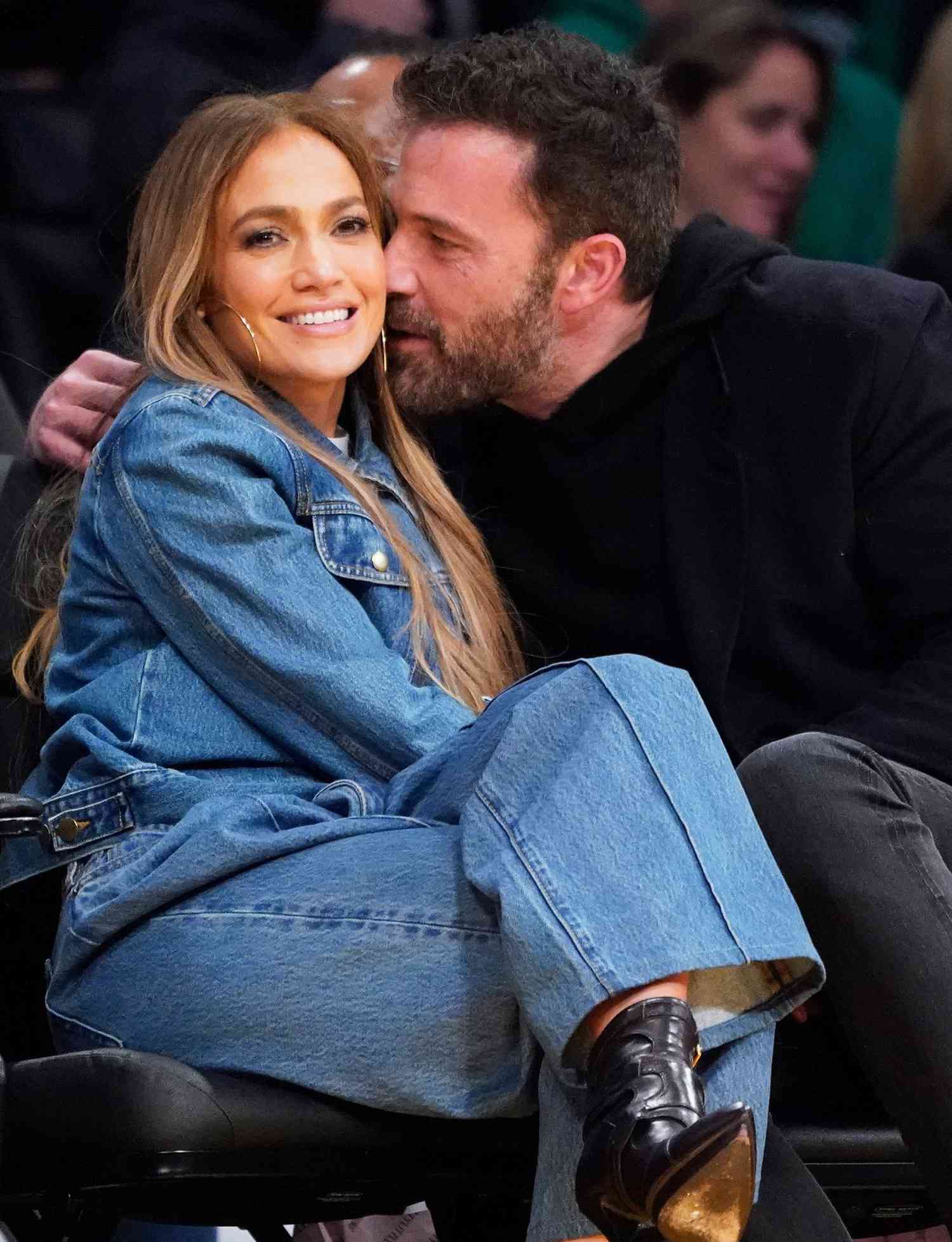 Jennifer Lopez, left, and Ben Affleck attend an NBA basketball game between the Los Angeles Lakers and the Boston Celtics on Tuesday, Dec. 7, 2021, in Los Angeles. (AP Photo/Marcio Jose Sanchez)