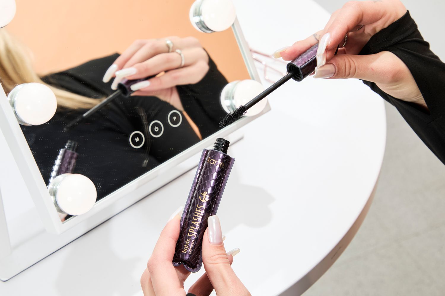 A person removes the cap on the Tarte Lights, Camera Splashes Waterproof Mascara