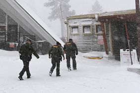Placer County sheriffs walk toward the medical clinic at Palisades Tahoe on Wednesday, Jan. 10, 2024, in Tahoe, Calif