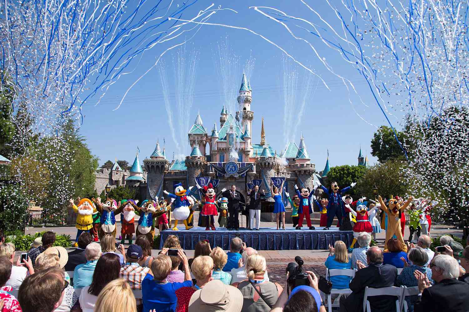 ANAHEIM, CA - JULY 17: In this handout photo provided by Disney parks, Mickey Mouse and his friends celebrate the 60th anniversary of Disneyland park during a ceremony at Sleeping Beauty Castle featuring Academy Award-winning composer, Richard Sherman and Broadway actress and singer Ashley Brown July 17, 2015 in Anaheim, California. Celebrating six decades of magic, the Disneyland Resort Diamond Celebration features three new nighttime spectaculars that immerse guests in the worlds of Disney stories like never before with "Paint the Night," the first all-LED parade at the resort; "Disneyland Forever," a reinvention of classic fireworks that adds projections to pyrotechnics to transform the park experience; and a moving new version of "World of Color" that celebrates Walt Disneys dream for Disneyland. (Photo by Paul Hiffmeyer/Disneyland Resort via Getty Images)