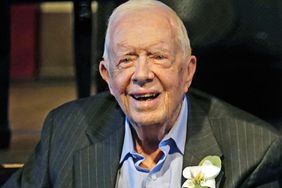 Former President Jimmy Carter smiles as his wife former first lady Rosalynn Carter speaks during a reception to celebrate their 75th wedding anniversary Saturday, July 10, 2021, in Plains, Ga.. (AP Photo/John Bazemore, Pool)