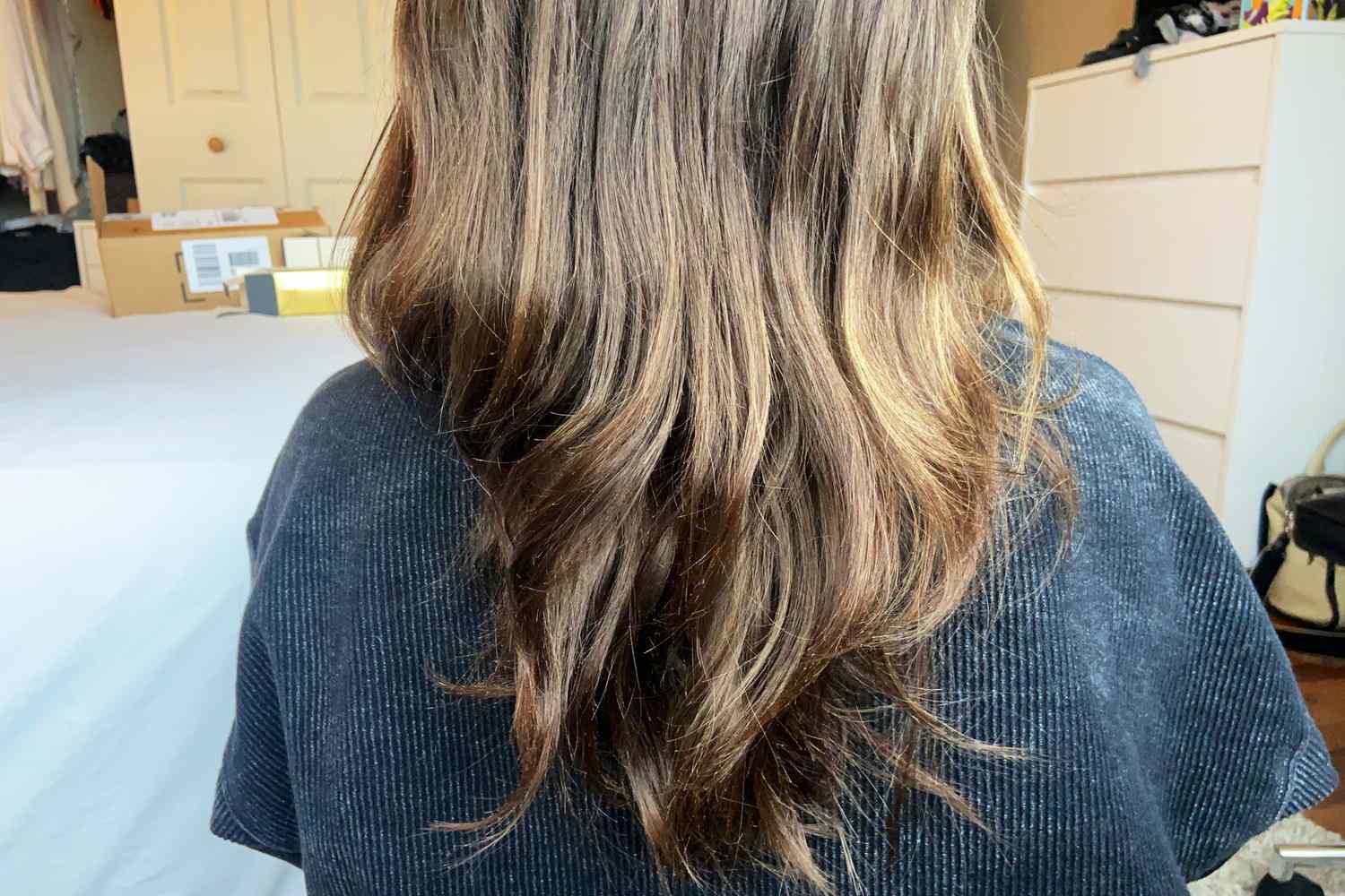 A person's hair after using Oribe Gold Lust Repair and Restore Shampoo and Conditioner