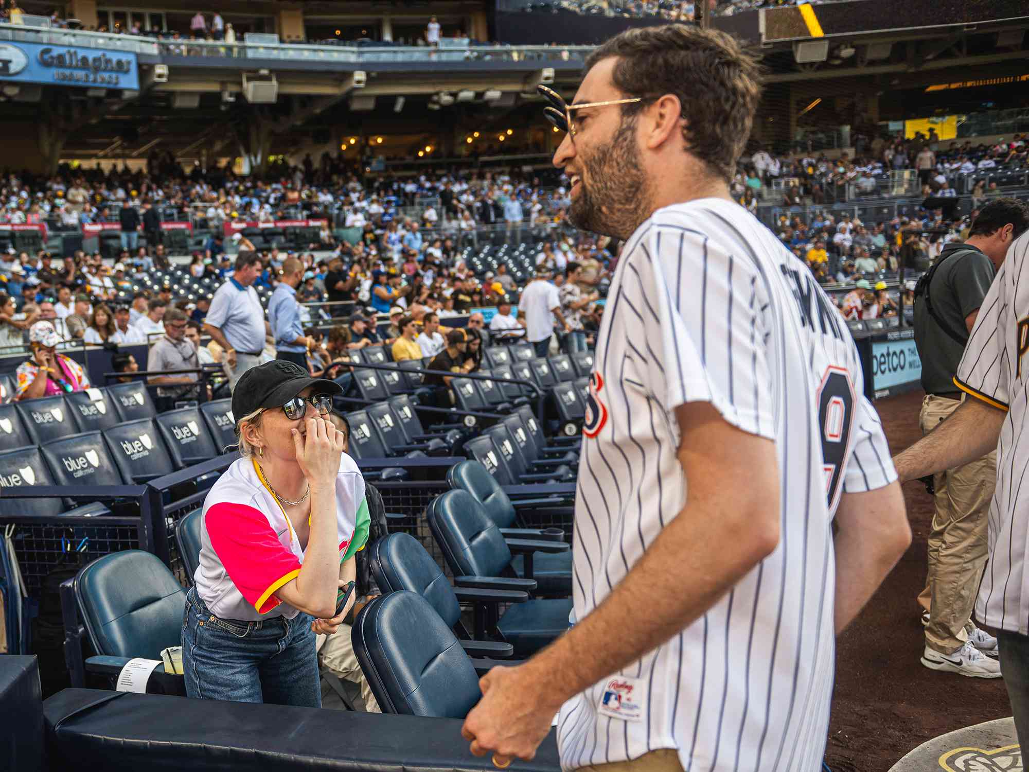 Actress Emma Stone and her husband Dave McCary on the field after McCary threw out the ceremonial first pitch before the San Diego Padres face against the Los Angeles Dodgers on August 5, 2023