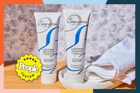 tested lifestyle image of Embryolisse Lait-CrÃ¨me ConcentrÃ© tubes, one of which is in a dish with white hand towel