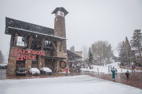 Skiers walk to the base of Jackson Hole Mountain Resort on Dec. 12, 2021 in Teton Village, Wyo