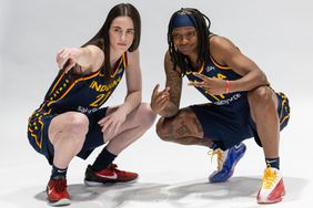 Caitlin Clark #22 and Erica Wheeler #17 of the Indiana Fever pose for photographers during media day activities at Gainbridge Fieldhouse on May 1, 2024 in Indianapolis, Indiana