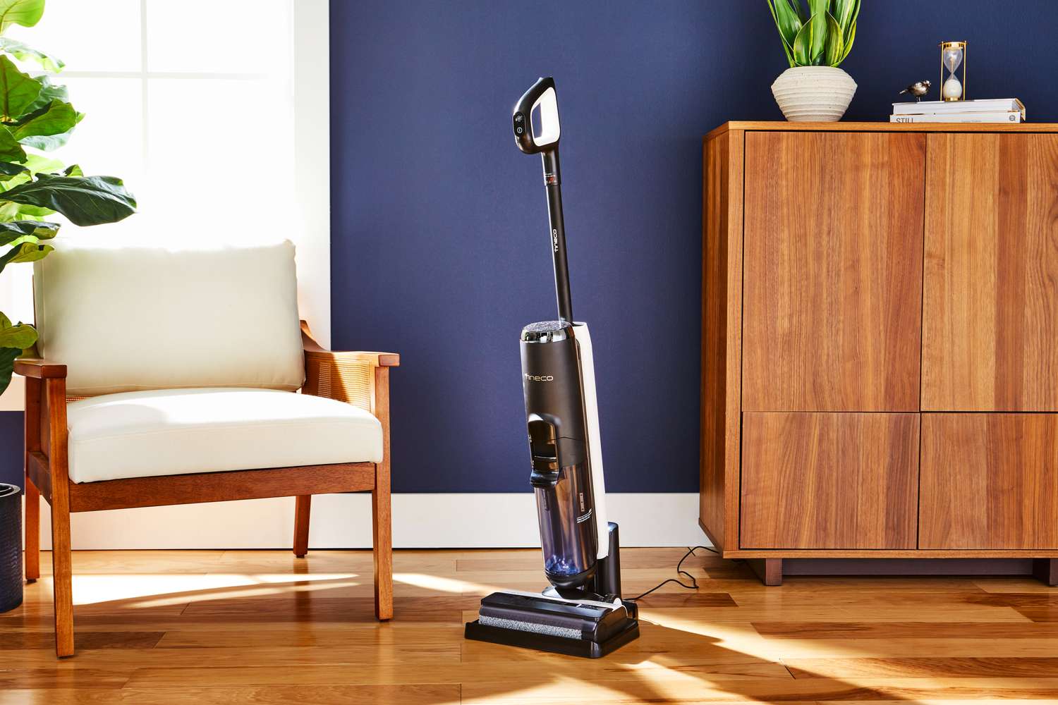 Tineco Floor One S5 Cordless Wet/Dry Vacuum Cleaner on a wooden floor next to furniture