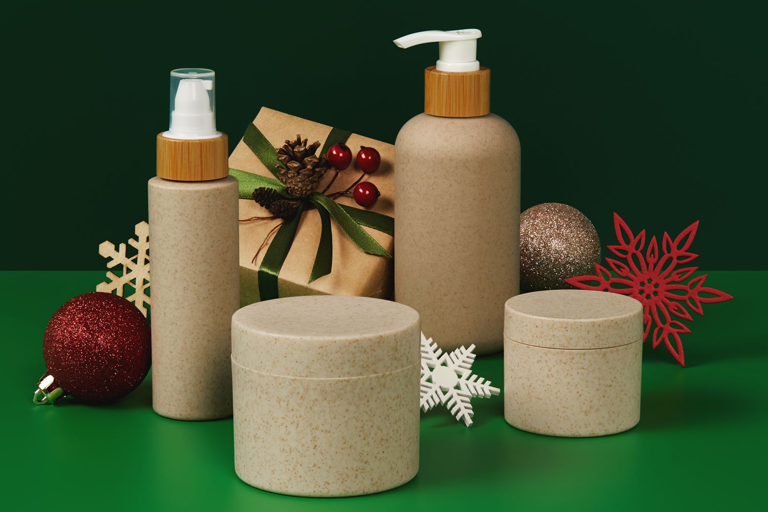organic cosmetics packaging from natural materials on green table with wooden Christmas ornaments
