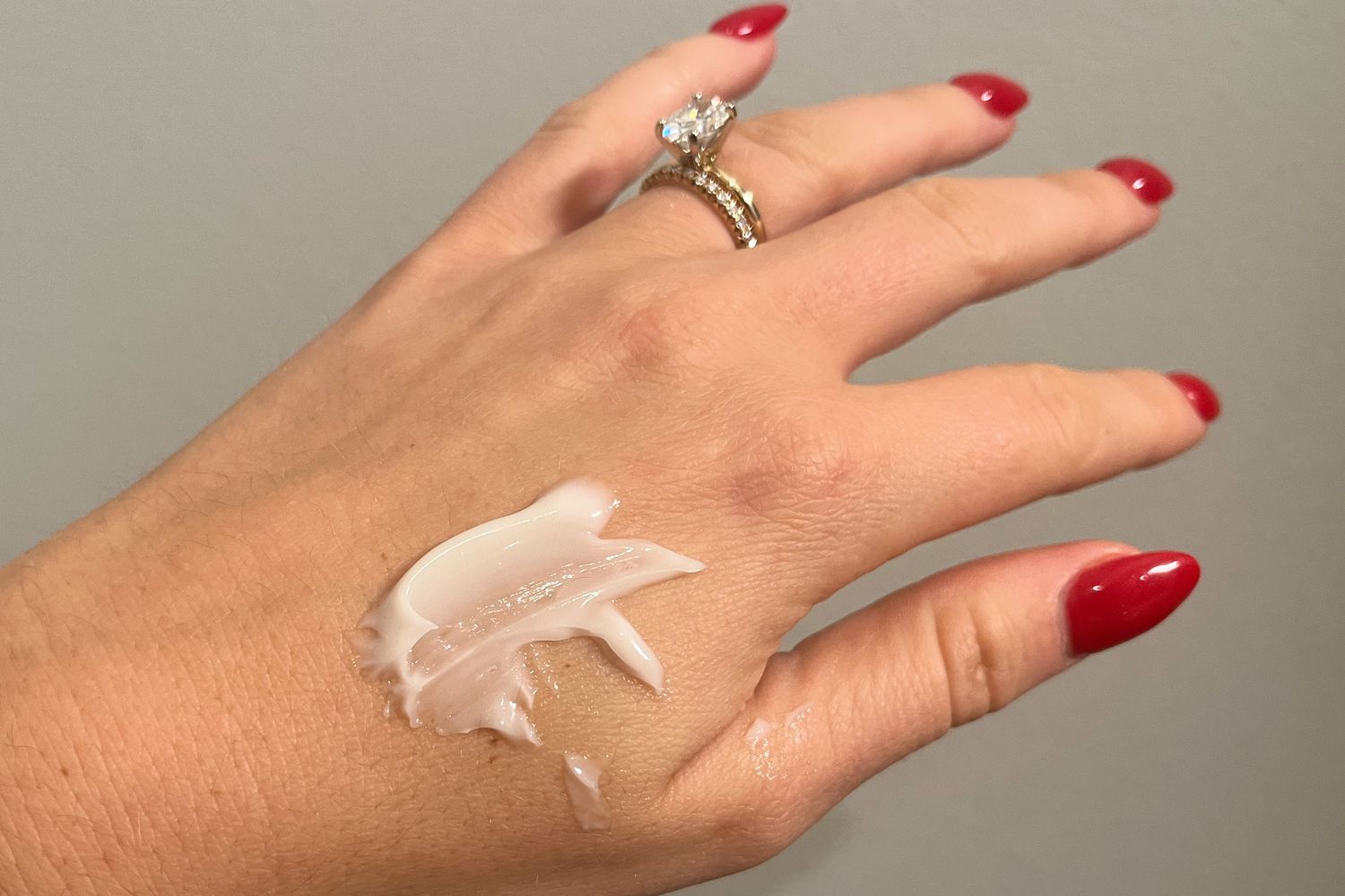 A smear of Estee Lauder Revitalizing Supreme+ Moisturizer Youth Power Creme on a person's hand