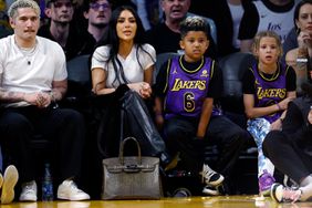 Kim Kardashian and her son Saint West attend a basketball game between the Los Angeles Lakers and Golden State Warriors at Crypto.com Arena on March 16, 2024 