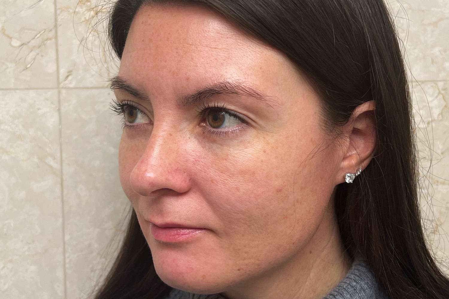 A person showing the side of their face during testing of the Clinique Smart Clinical Repair Wrinkle Correcting Serum