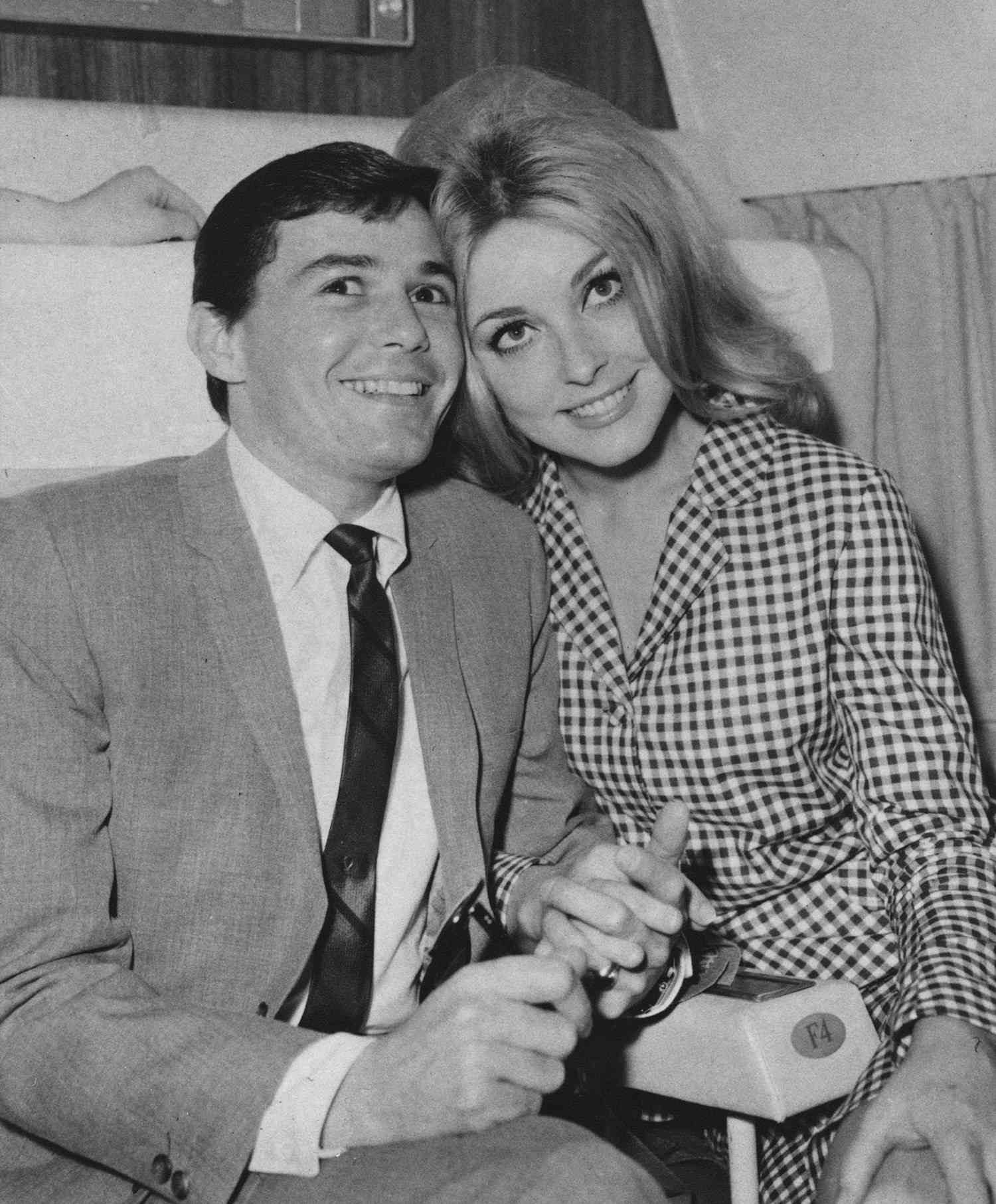 Sharon Tate and hair dresser Jay Sebring pose for a portrait on a plane circa 1966